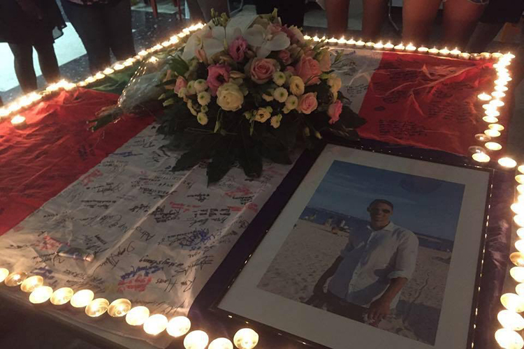 A vigil for Nicolas "Nick" Leslie with his photo, flowers, and candles, held after the July 2016 attack in Nice.