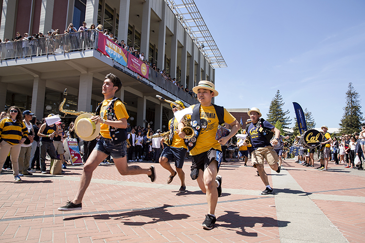 Cal Band members rush to the Lower Sproul steps at the start of the Cal Day Spriti Rally during Cal Day at UC Berkeley on Saturday, April 21, 2018.