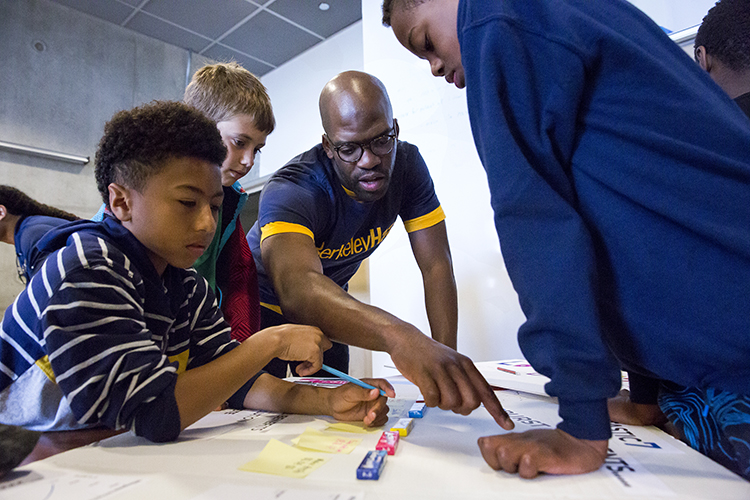 A key part of the program was teaching students to work together. Here, first year MBA student Bosun Adebaki helps his group prepare for their presentation. (UC Berkeley photos by Brittany Hosea-Small)