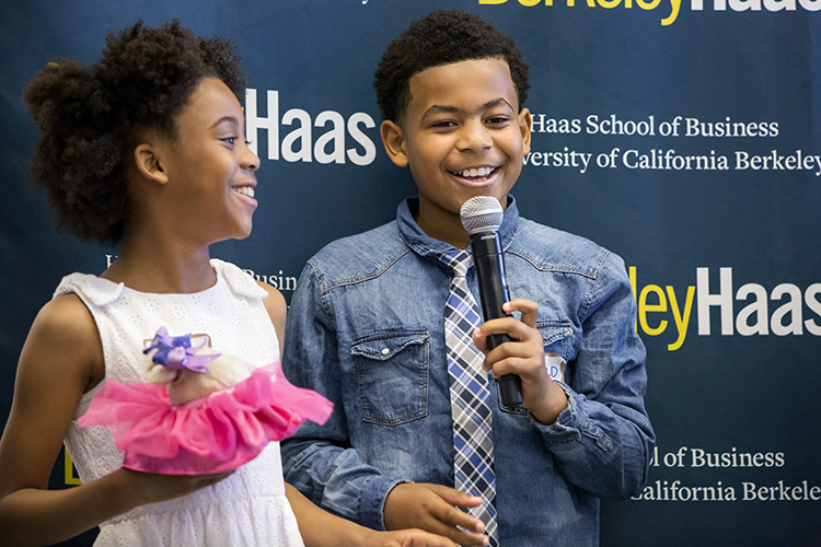 Ronald Perry, 10, and Asha Glenn, 9, present their business plan for customizable slippers. Many of the students dressed up in special outfits for their presentations.