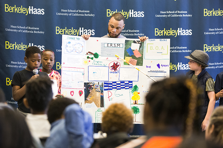 UC Berkeley MBA student Brandon White stands with his group of Emerson Elementary students as the present their business plan during the Cheetah Tank presentation day at the UC Berkeley Innovation Lab on Friday, May 4, 2018.