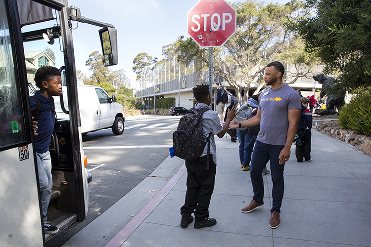 UC Berkeley MBA student Brandon White greets Emerson Elementary students as they arrive for the Cheetah Tank presentation day at the UC Berkeley Innovation Lab on Friday, May 4, 2018.