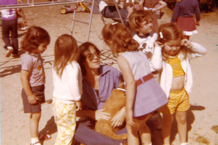 Marcy Whitebook with kids on a playground