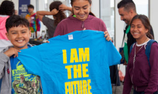 kids with "I am the future" T-shirt