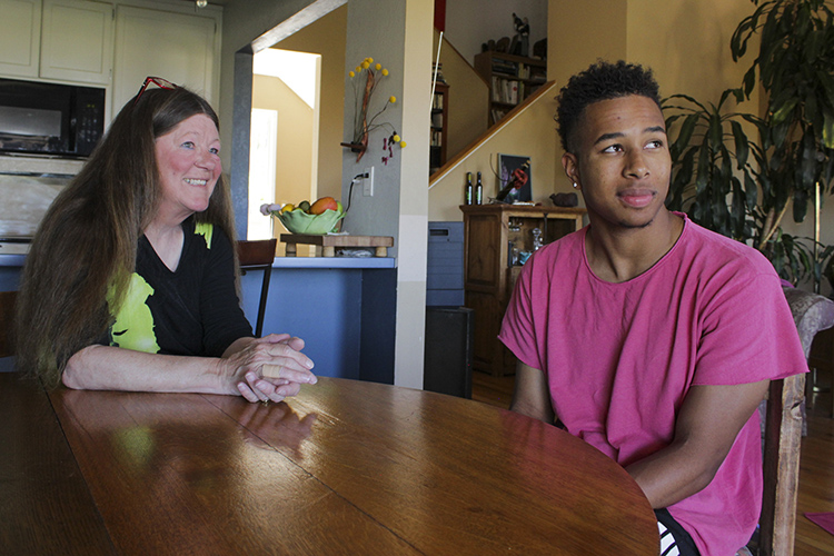 Teryl Burt and Cameron Rentie sit at Burt's table in her home