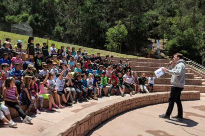 Patrick Laird giving a speech to young students about reading