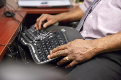 a person uses a keyboard on their lap
