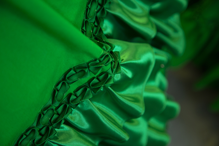 Close-up detail of the more than 200 feet of fabric ruffles and custom ribbon trim that artist Stephanie Syjuco produced by hand to create the Civil War garment.