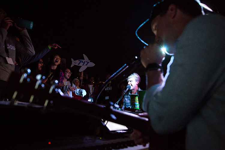 musicians perform for students at night