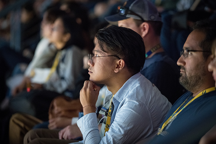 student listens intently at a welcome event