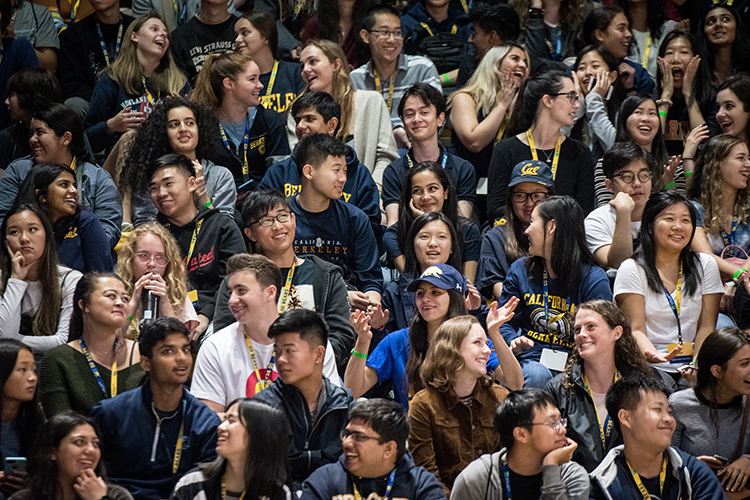 students sitting on bleachers talking