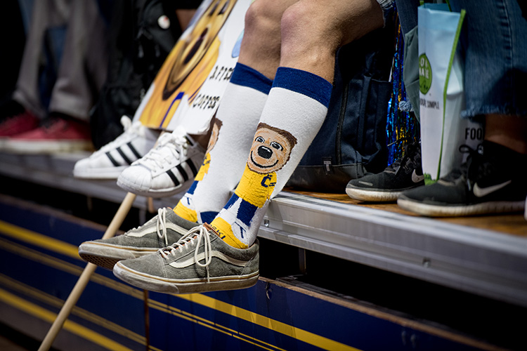 A student sports shin-high socks featuring the beloved Berkeley mascot, Oski bear