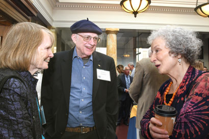 Margaret Atwood talks with two people are a reception