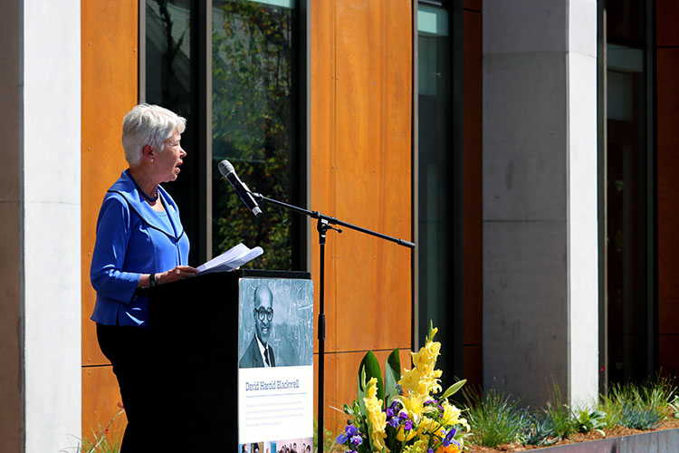 Chancellor Carol Christ talks at a podium