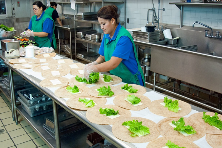 restaurant workers making salads