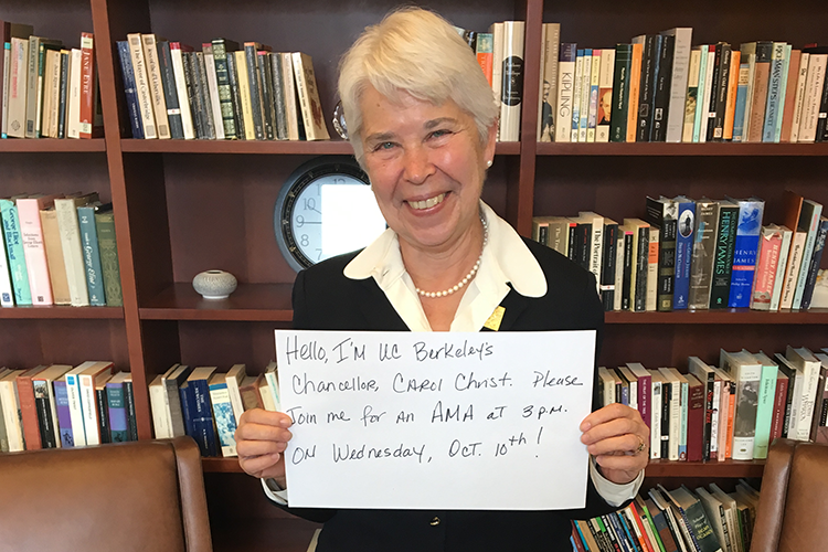 Carol Christ with a sign reading, Hi, I'm UC Berkeley's Chancellor, Carol Christ. Please join me for an AMA at 3 p.m. on Wednesday Oct. 10th