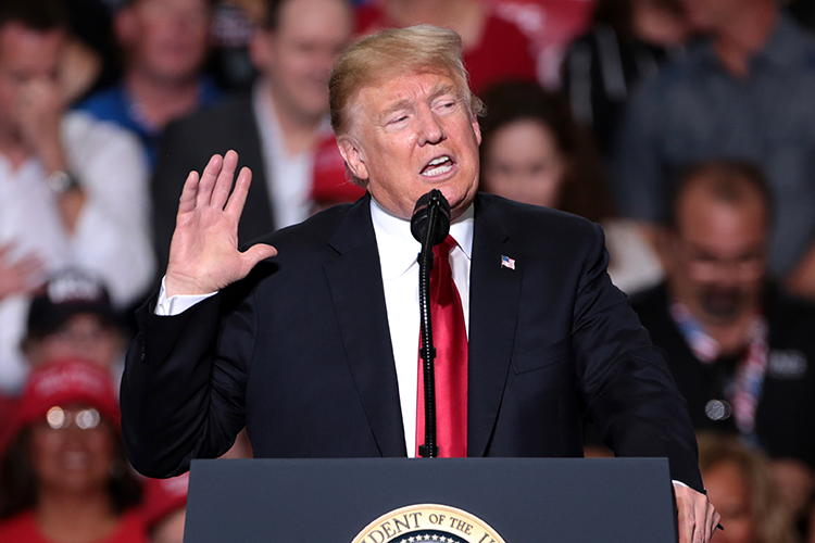 president trump speaks at a podium