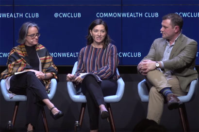 panel of three people sitting on stage