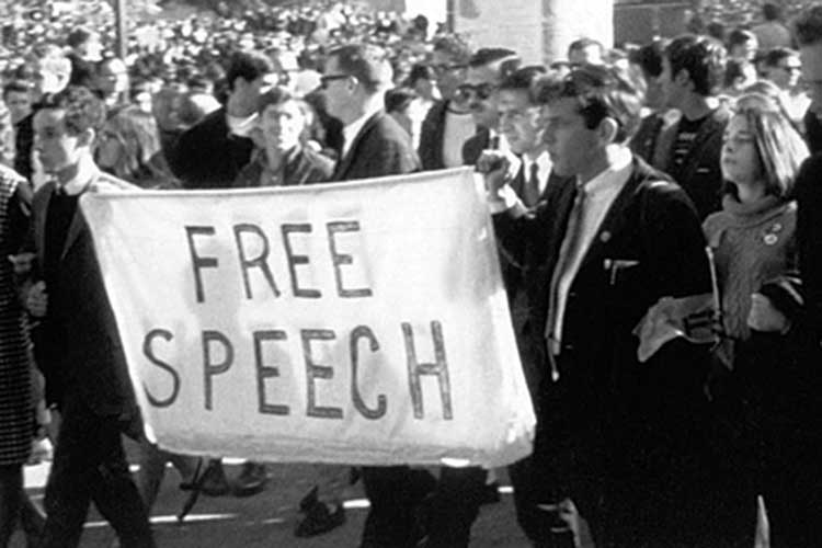 students marching with free speech banner