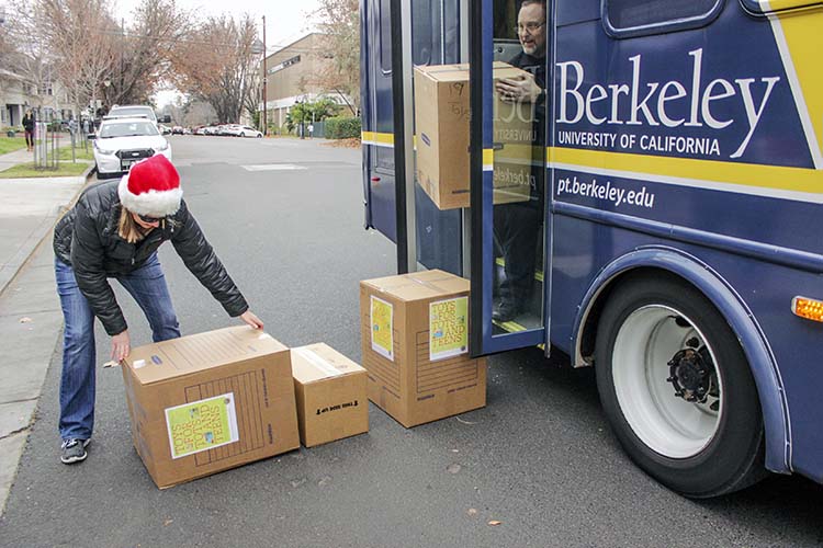 a woman in a santa hat lifts a box