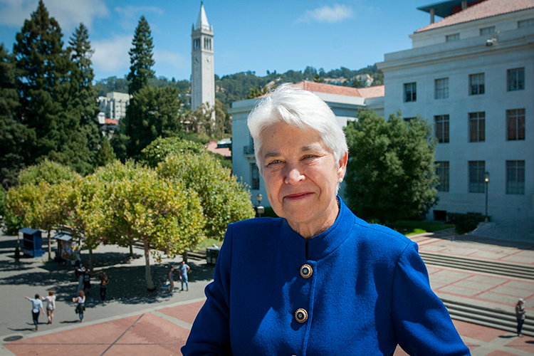 Carol Christ smiling in front of the campus