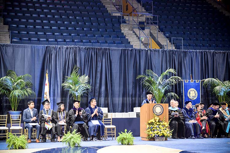 a woman stands at a podium