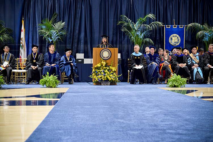 a woman speaks at a podium