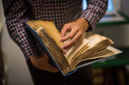 a person leafs through an old book