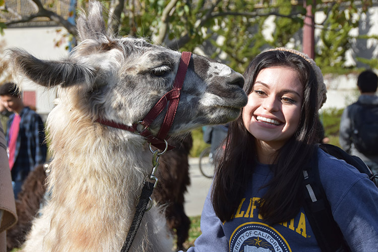 And ... a kiss from Quinoa brings a smile. (UC Berkeley photo by Hulda Nelson)