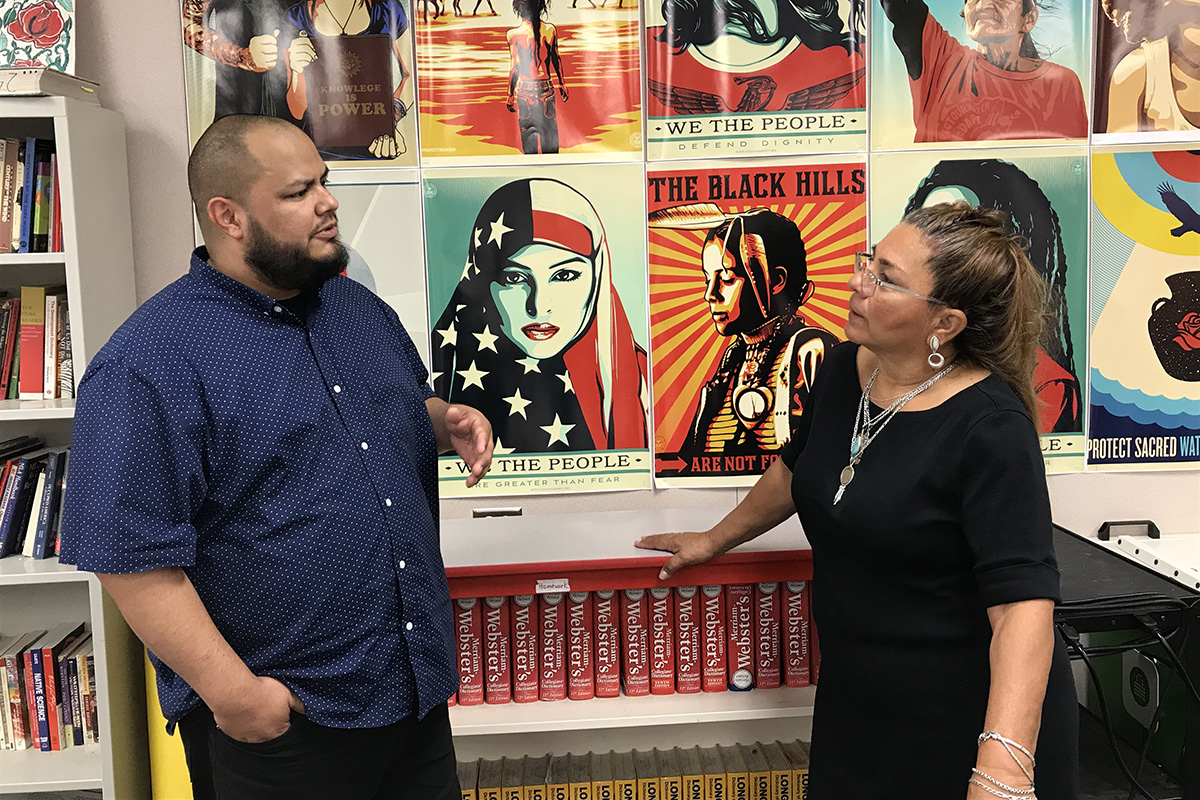 Johnny Gonzalez, a teacher at Desert Mirage High School, talks with Luisa Armijo