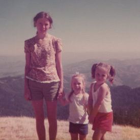 Tonia as a young adult with Erika and Inger as kids standing outside smiling