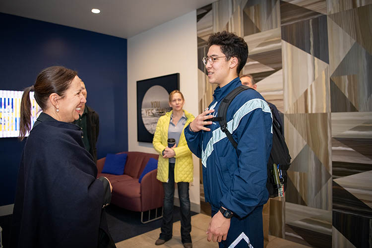 a woman talks with a young man