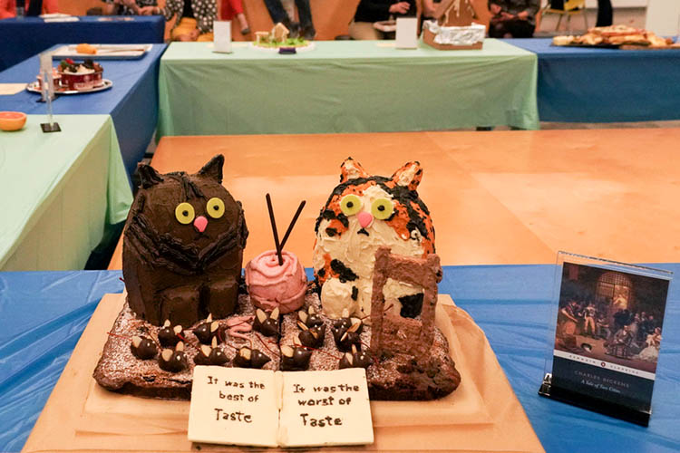 an image of a cat cake next to a dickens book