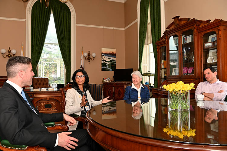 four people talking at a table