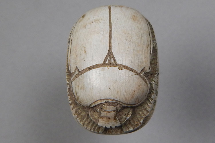 A white Egyptian scarab carving