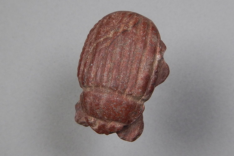 A red-colored Egyptian scarab