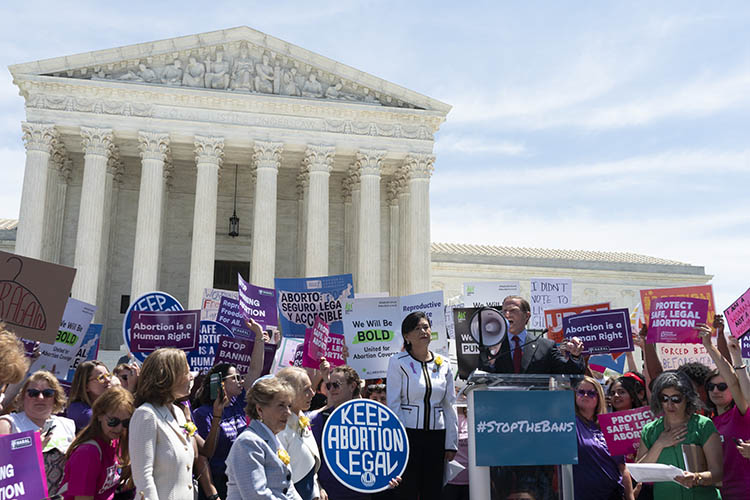 a group gathers outside the supreme court