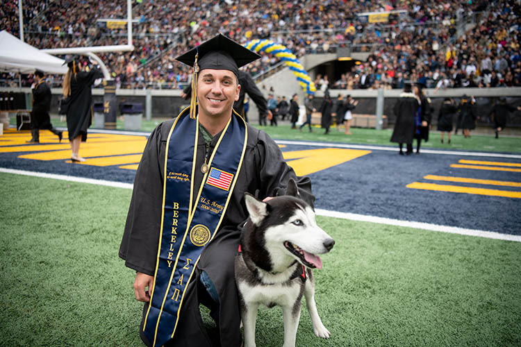 a graduate with a dog