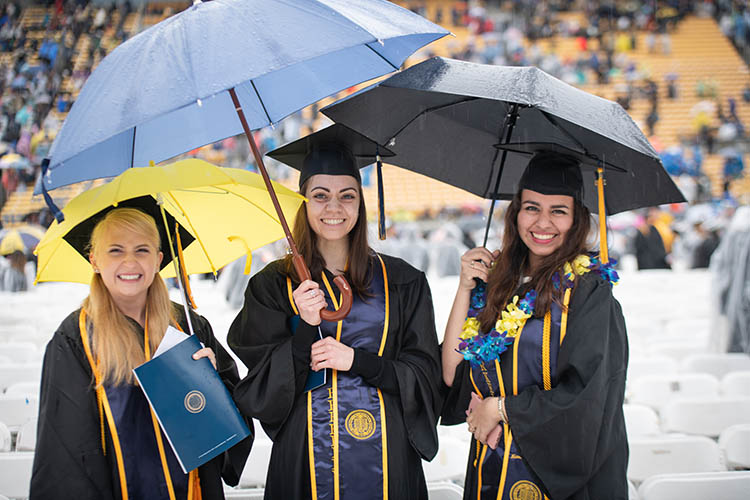 students stand in the rain
