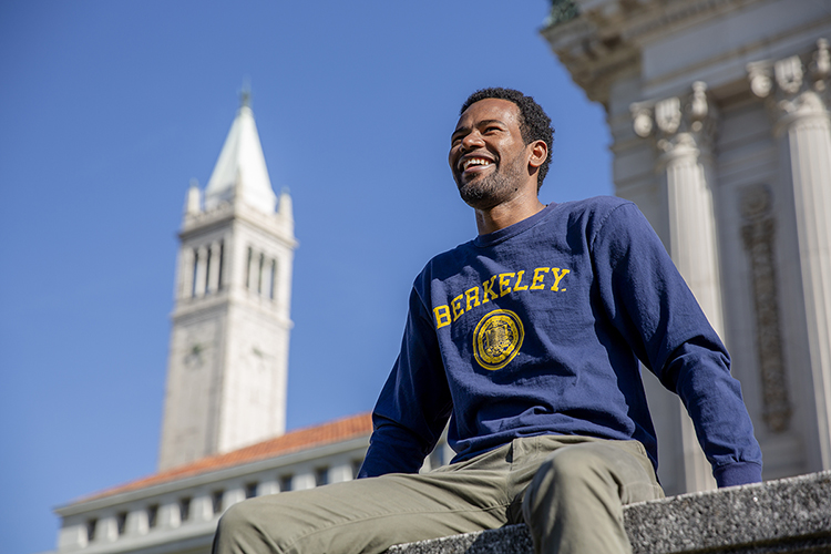 Lelisa sitting on ledge with the Campanile in the background