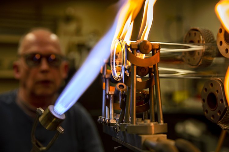Jim Breen flares the end of a glass tube and makes a shock-resistant edge. 