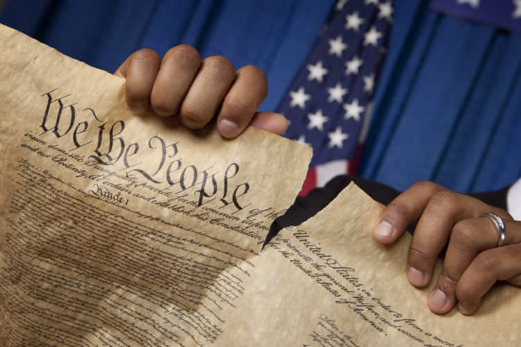 U.S. Constitution being torn