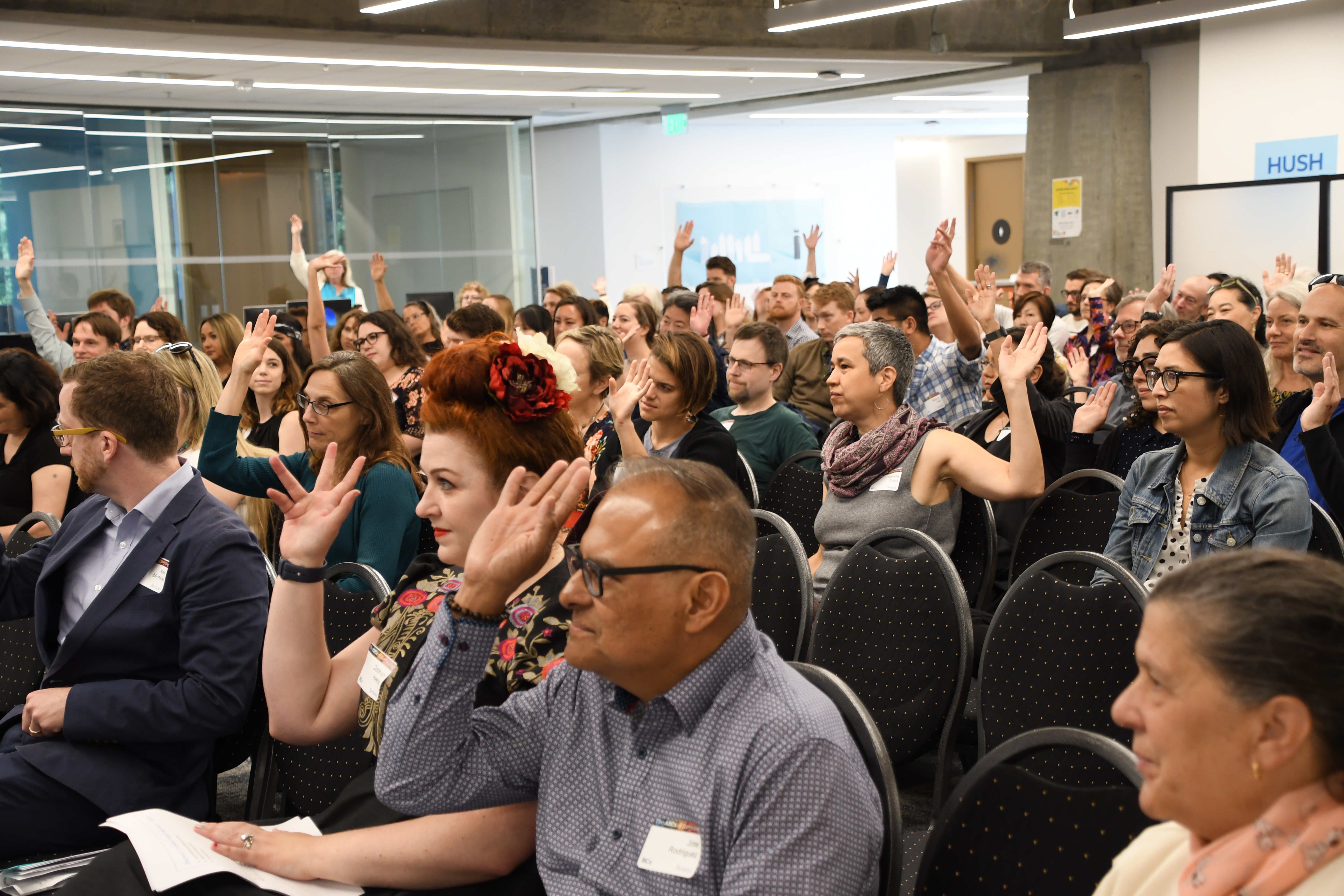 Audience holding up hands at 2019 BC2 Conference