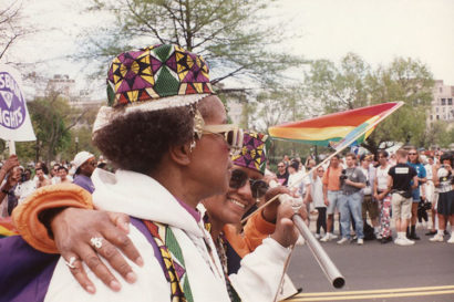 people marching and waving rainbow flags at the 1993 march on washington