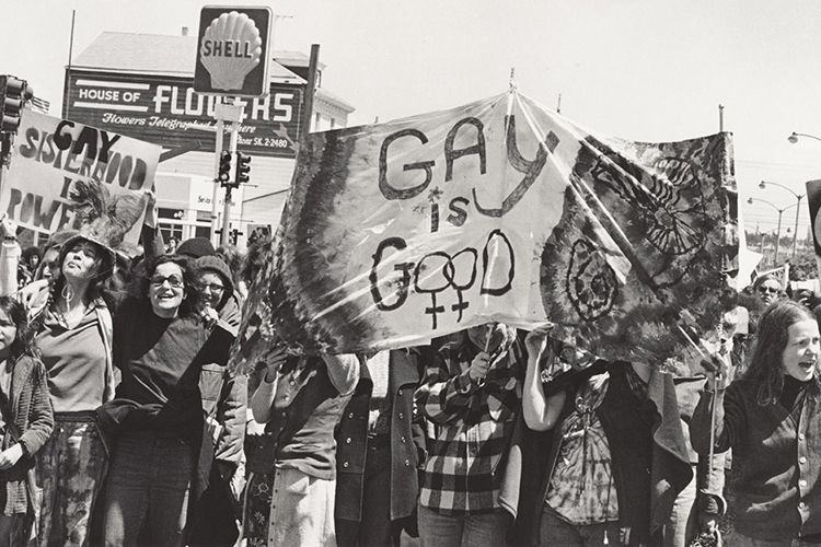 pride parade with women holding signs