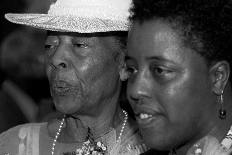 Mable Howard and her daughter Mildred looking at something out of the photograph