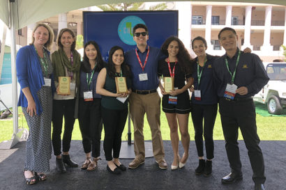 award winners stand together holding awards