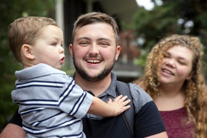 Blake Danser smiles with his son, Henry, and wife, Kayley