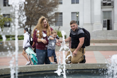 Blake and Kayley with their son Henry at a fountain