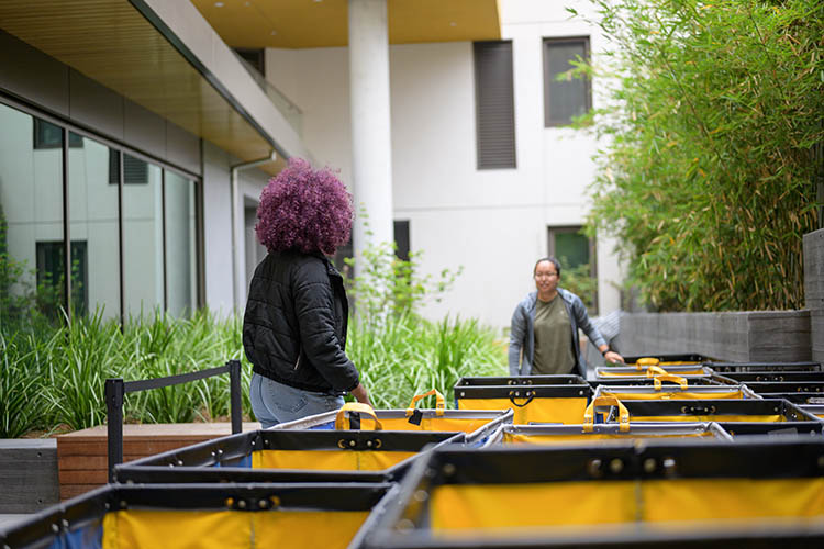 two people stand with carts